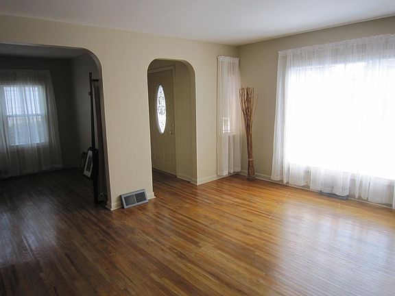 Living looking into dining with hall that has a coat closet.