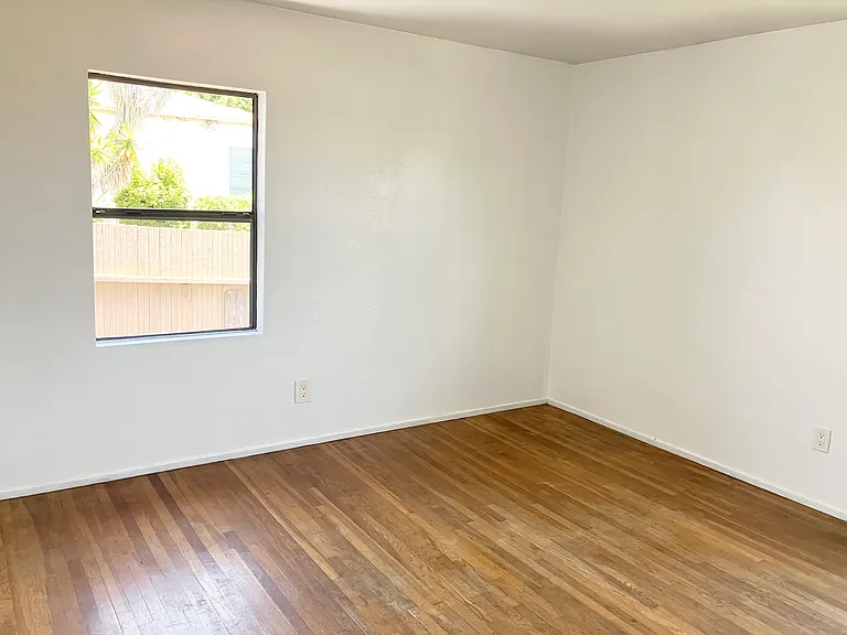 Bedroom on east corner of house, window facing alley