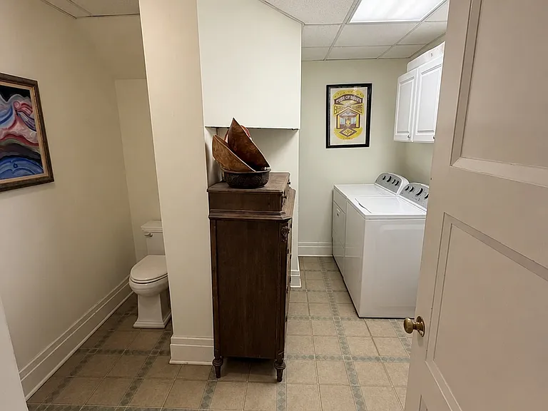 Basement utility area with laundry, storage, and additional bathroom access.