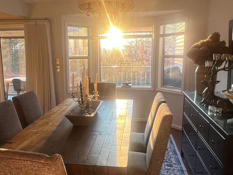 Large dining table at bay window at sunset