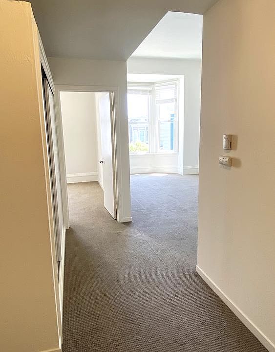 Main Hallway: Living Room on the right. Front Bedroom on the left. Both rooms have lots of natural light and high vaulted ceilings.