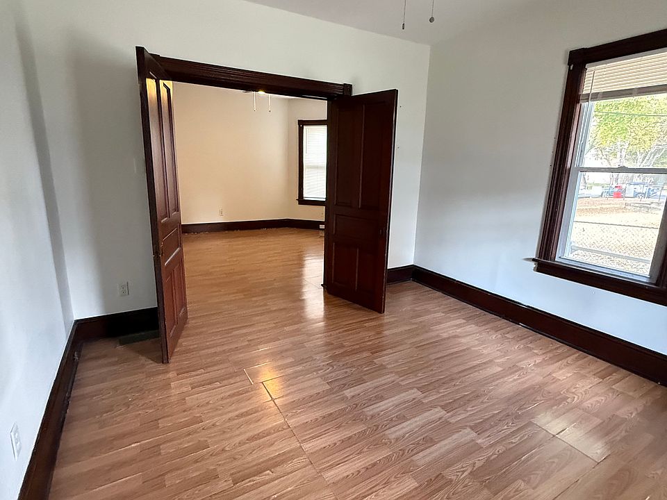 Bedroom leading to foyer / living area through barn doors