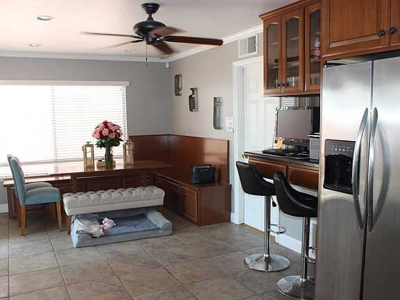 built in bench with cabinet storage underneath, matching table are part of the home, room for 2 bar stools (not included)