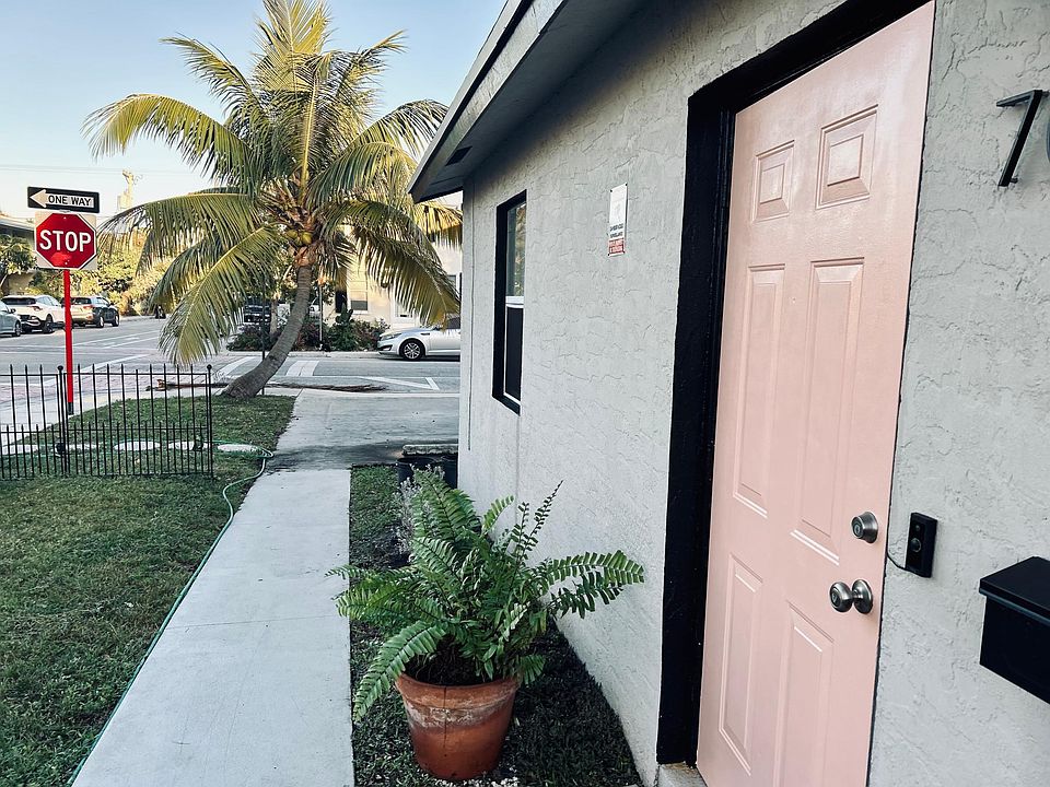 FRONT DOOR AND WALKWAY TO PARKING.