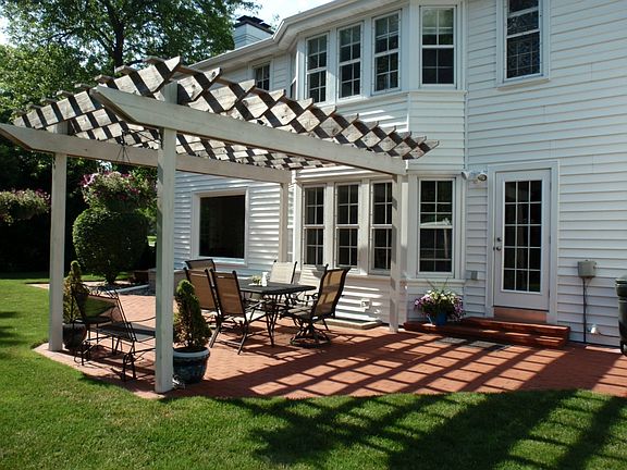 Beautiful Brick Paver Patio with the Quality Built Arbor overhead Located just off the Dining Room & Kitchen which makes it Great for Grilling ....