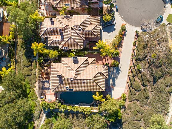 Top-down image of home and long private drive.