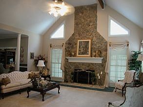 Beautiful rock fireplace in open family room.