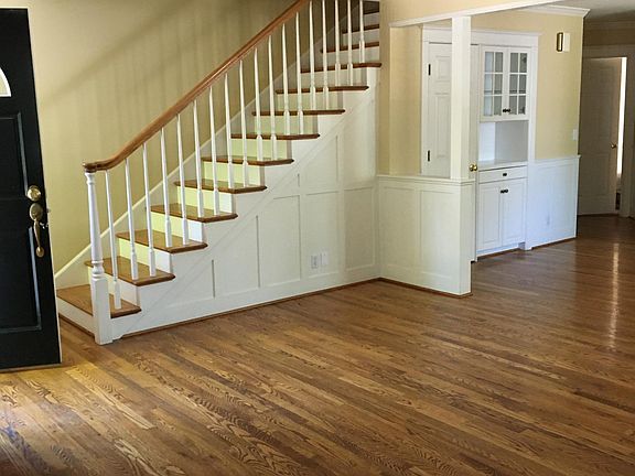 Stairs, front closet, built-in china cabinet, hardwood flooring.