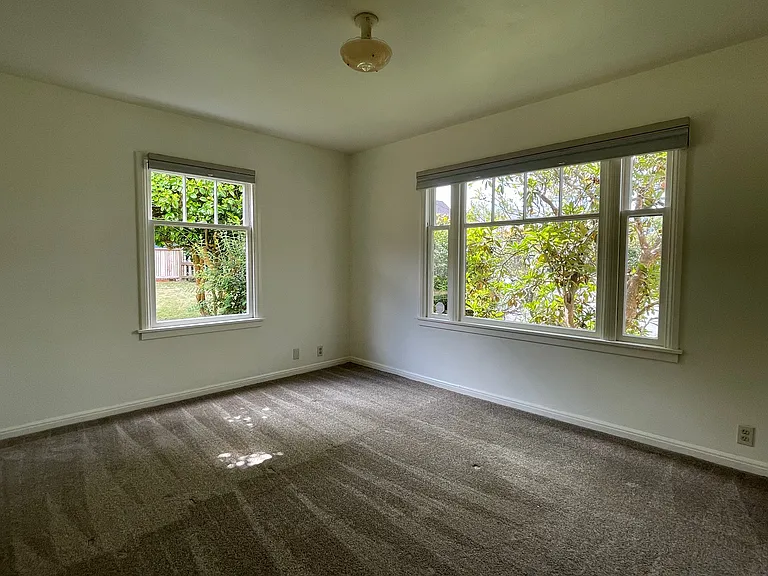 Primary bedroom with 1/2 bath and full closet. View into the garden