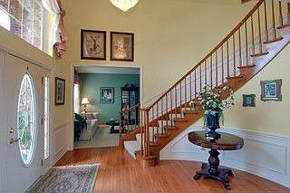 Two story foyer with hardwood and dual entry staircase