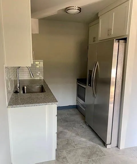 New stainless-steel appliances in kitchen.