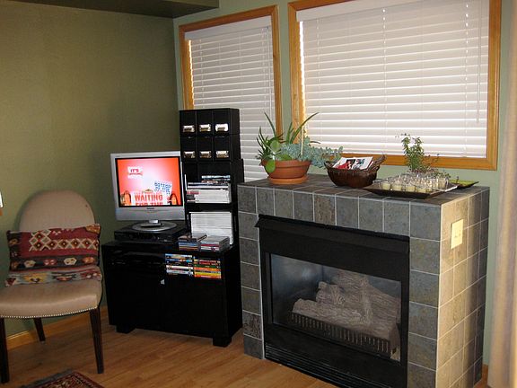 Gas fireplace. Next to the fireplace is a sliding glass door to a deck.