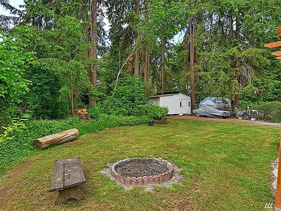 Backyard complete with fire pit, spacious deck, garden shed, RV parking, fully fenced and more!