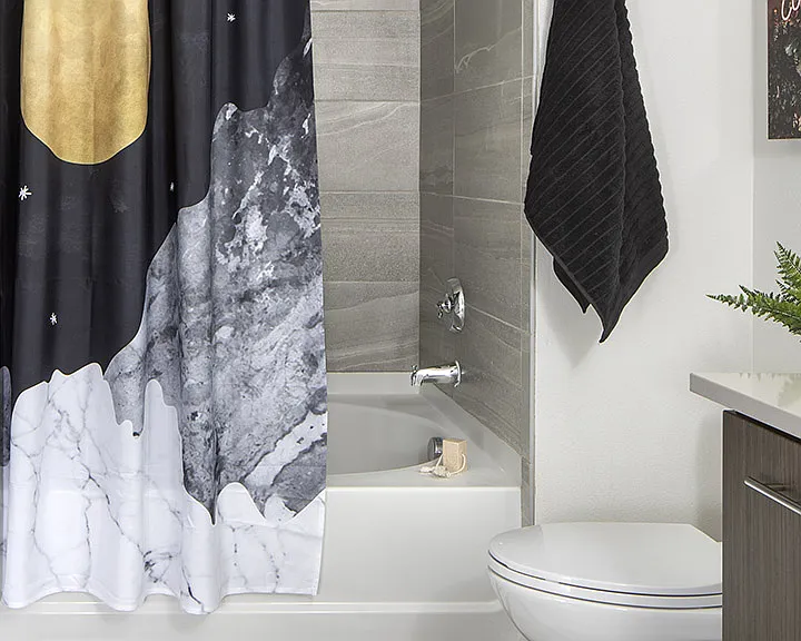 Apartment bathroom with large soaking tub and wood-style flooring.
