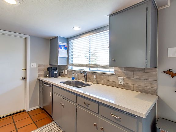 Bright kitchen. Door to left to laundry room, water heater and additional exit.