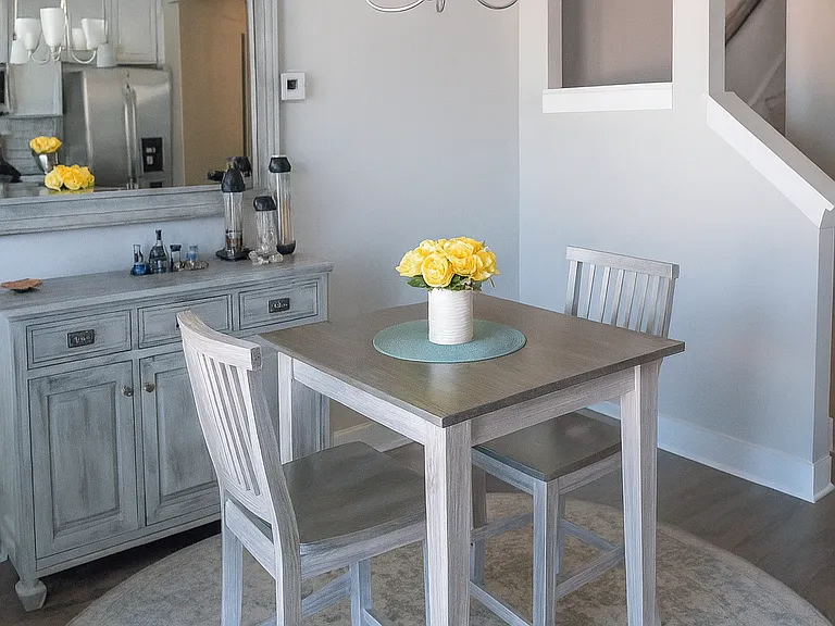 Inviting dining space with room for gatherings, highlighted by a chic chandelier.