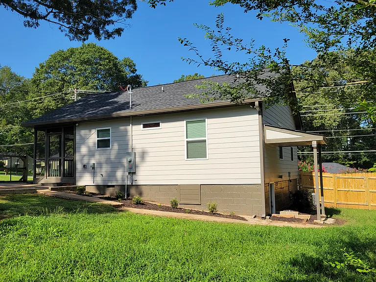 On a corner, double-lot with a fenced-in back yard. Covered access to a "crawlspace" (6' ceilings!) with plenty of room for storage.