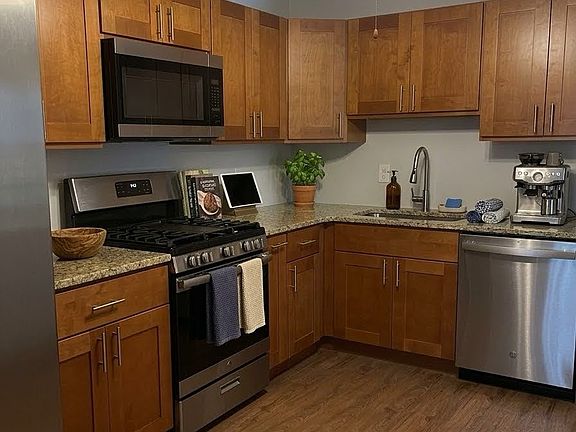 Kitchen with stainless steel appliances and garbage disposal.