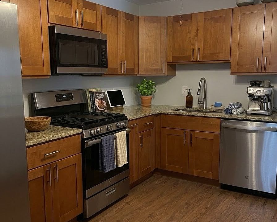 Kitchen with stainless steel appliances and garbage disposal.