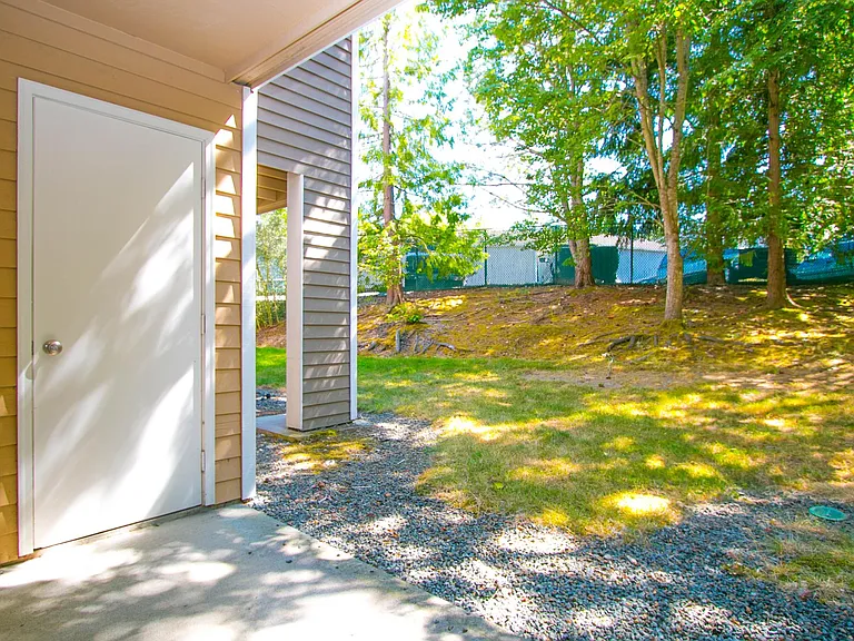 Outdoor covered patio with extra storage closet.