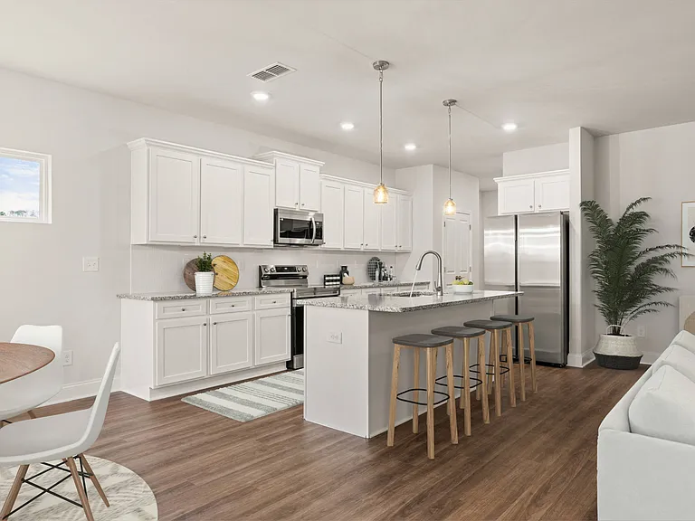 Spacious kitchen with an island, ample storage, and stainless steel appliances.