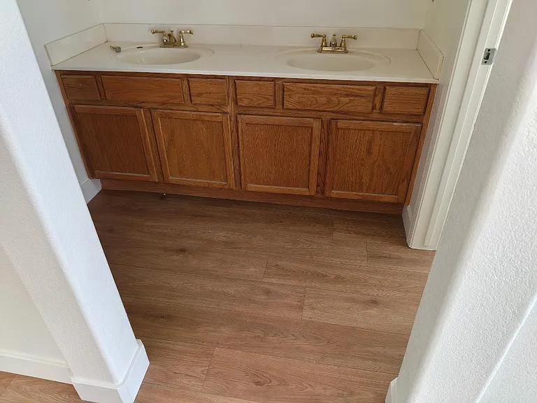 Master bath has double vanity and shower/toilet combo