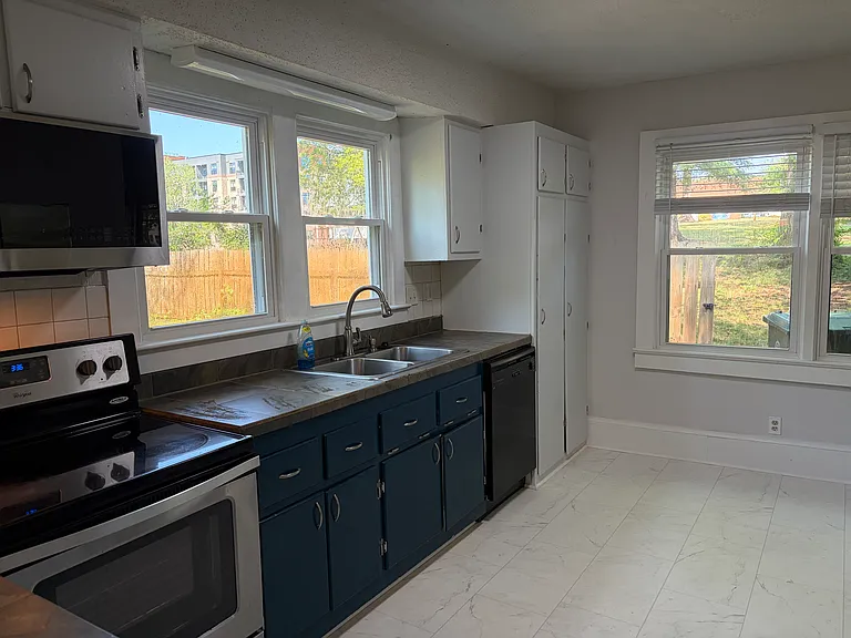 Sunny kitchen looks out to the backyard and side yard. Broom closet and pantry.