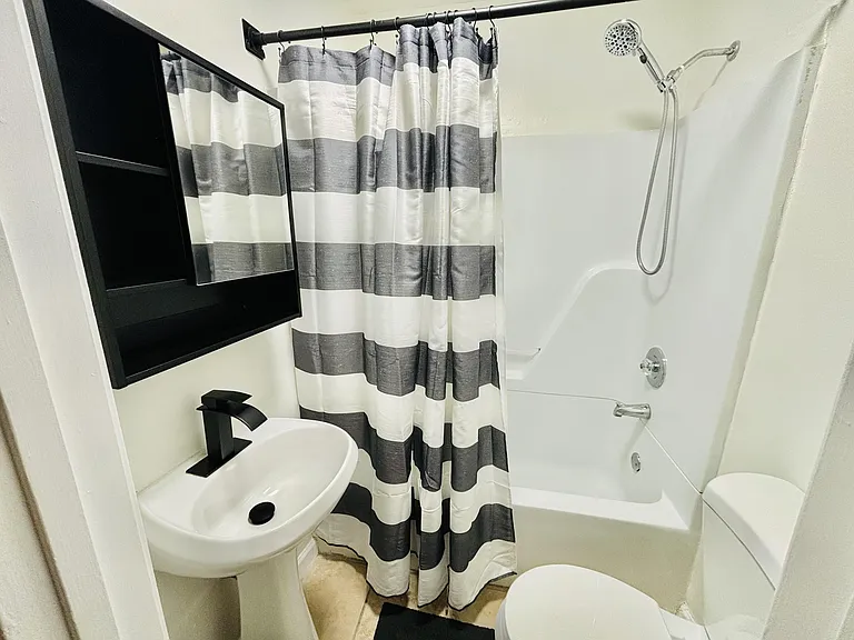 Shared hallway bathroom with tub and shower combo