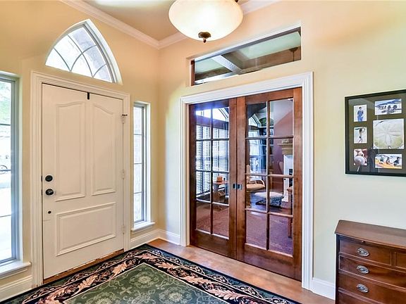 Entry. Glass doors with transom to go office. They are sliding pocket doors.