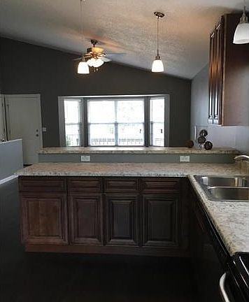 Beautiful kitchen with new cabinets and high low counter top for more space.
