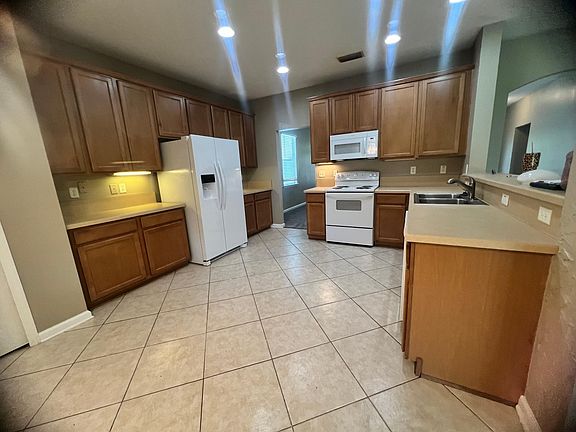 Brand new side by side fridge, stove, microwave and dishwasher