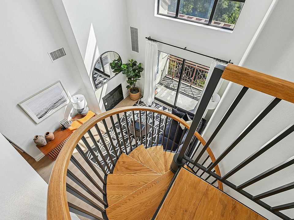 Bright and modern loft space with elegant spiral staircase