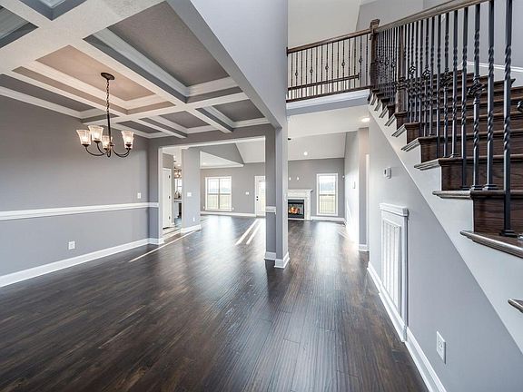 View of the Entrance with Breakfast/Dining Room Area to the left, stairwell to the catwalk on the right, master bedroom entryway to the right & living room with fireplace.