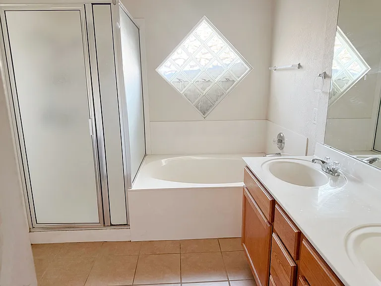 Master bathroom soaking tub, shower and double sinks.