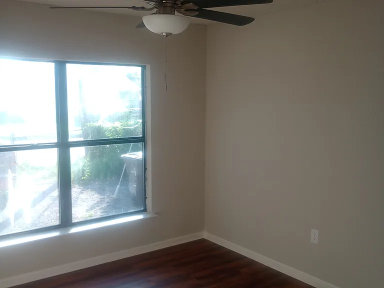 2nd bedroom completely remodeled with original hardwood flooring and ceiling fan