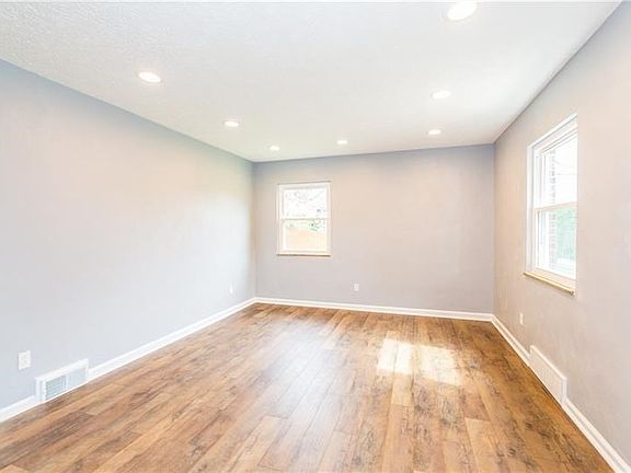 Living room has all new flooring, baseboard, windows, recessed lighting and is freshly painted in a neutral decor.