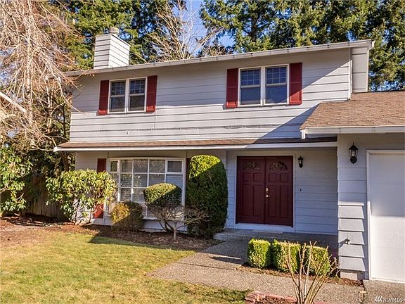 Colonial-Style Entry and Walkway - Double doors and red shutters accent this sweet home.
