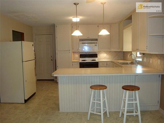 Snack bar with pendant lighting, and under cabinet lighting as well.