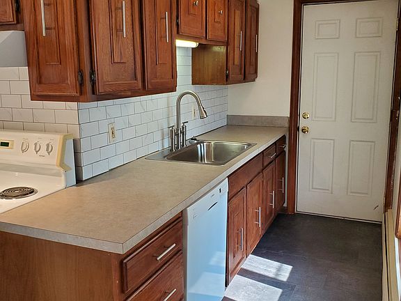 Kitchen has plenty of counter space and a new deep sink with bridge faucet