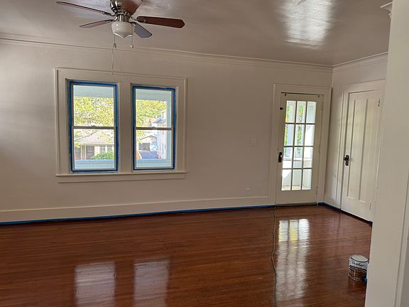 Living room showing porch door and windows overlooking the covered porch