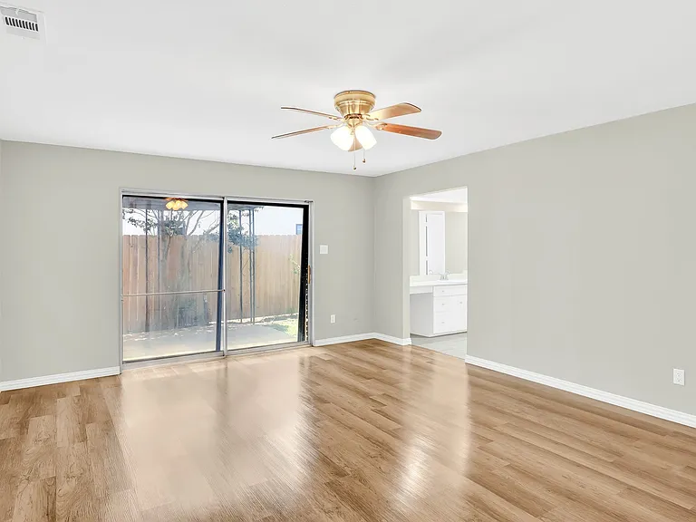 Oversized bedroom with ensuite bathroom and doors out to the patio.