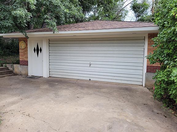 441 Harvard Lane oversized garage behind house with two parking spots, work area and storage shelves