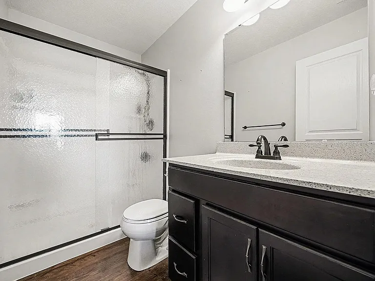 Start and end each day in comfort with a private primary bath featuring a spacious walk-in shower, generous vanity space, and clean, modern finishes.