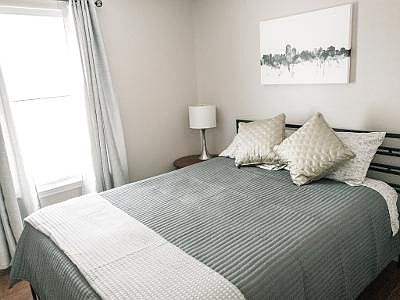 Bedroom 2 with dresser night stands and smart TV