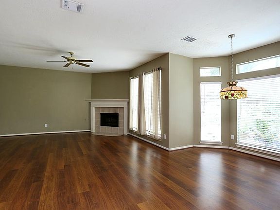 Spacious family room designed for informal gatherings with central fireplace.