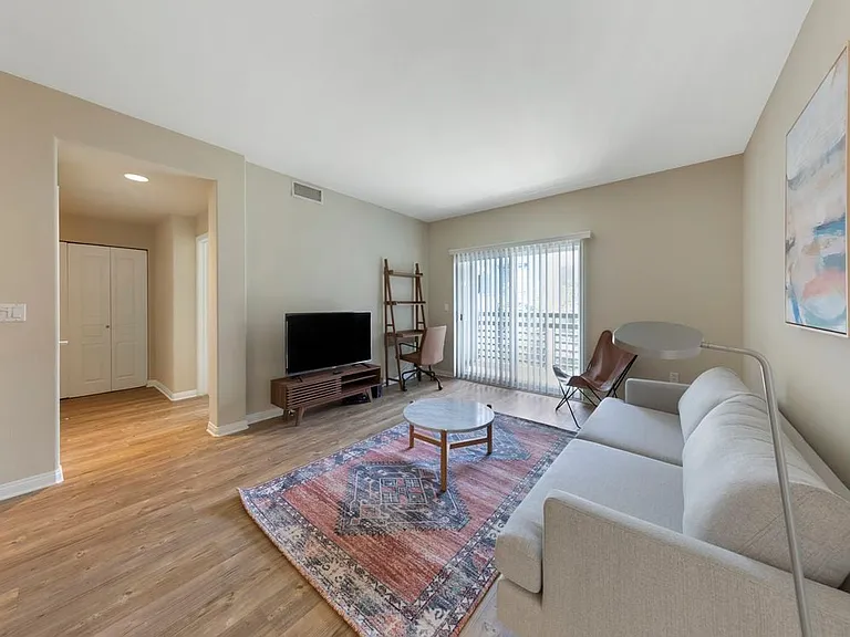 Furnished+ apartment homes come outfitted with a sofa, side chair, side table, coffee table, TV stand and 50" Television (Representative Image exact items and style of furnishings may vary)