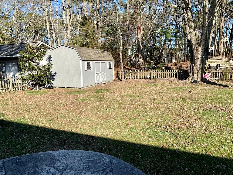 Rear yard area with fence and shed.