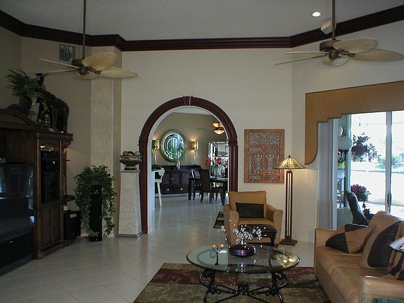 Stunning FAMILY ROOM view from entry shows beautiful Crown Molding & Water 