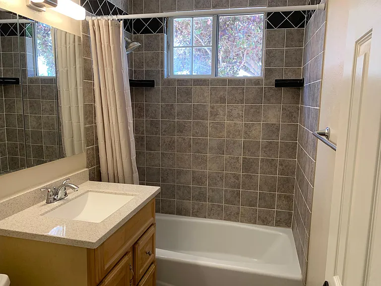 Bathroom with new tile and vanity.