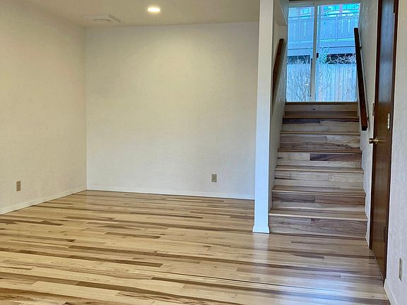 Living room with new hardwood floors, sightline to the second floor dining room with patio doors out to the garden.